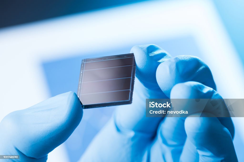 Scientist hold in hand small tile of new type efficient solar cell tile, solar technology research concept
